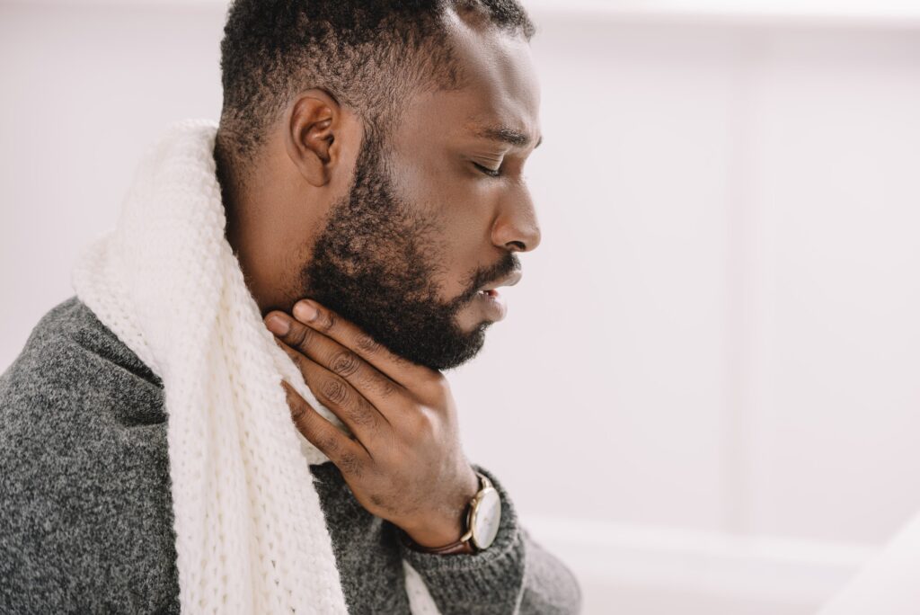 diseased african american man having sore throat