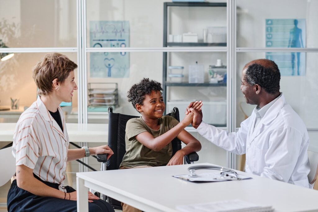 Doctor congratulating boy with recovery